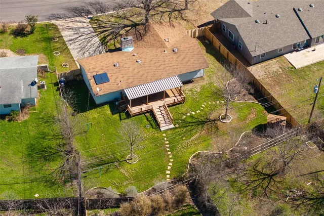 an aerial view of a house with a yard basket ball court