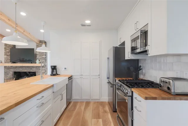 a kitchen with a sink stove and refrigerator