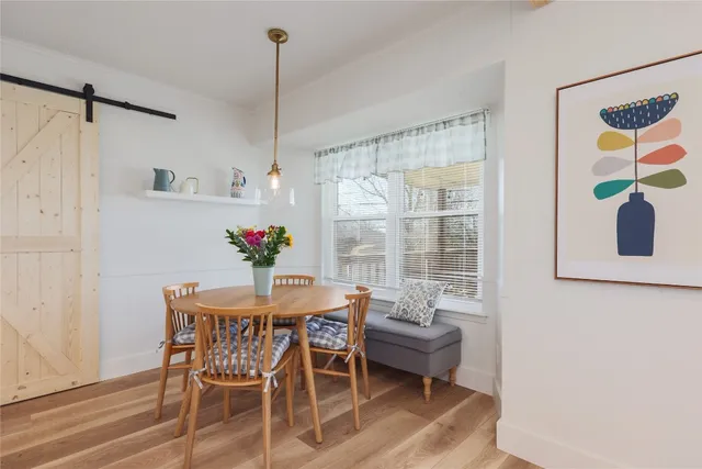 a dining room with furniture and window