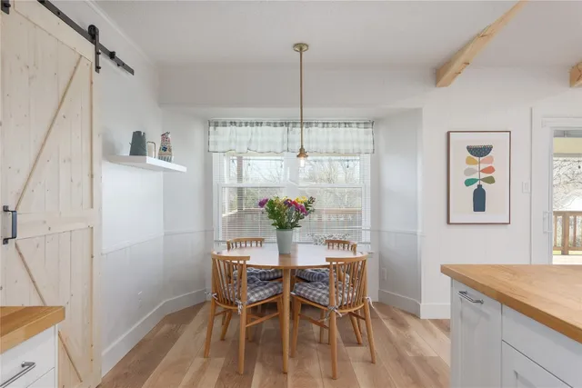 a dining room with furniture and window