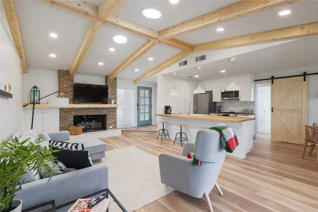 a living room with furniture a fireplace and a flat screen tv