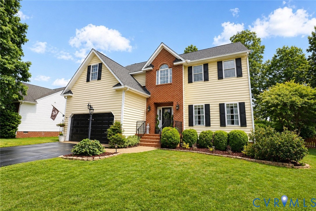 Traditional two-story residence featuring a brick