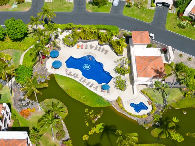 a view of a house with a swimming pool and sitting area