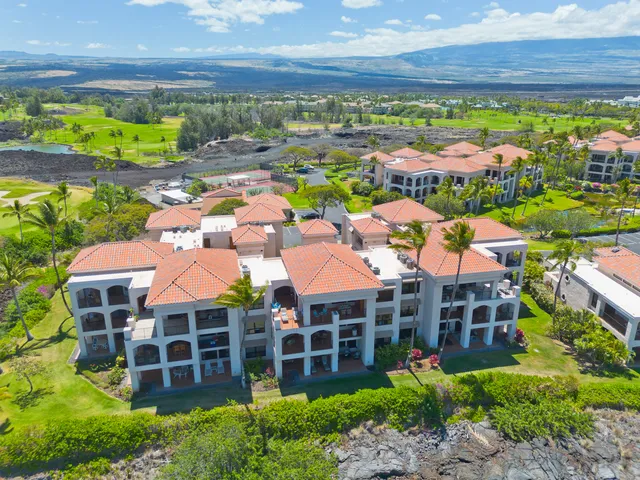 a view of a street with cars parked