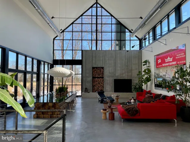 a room with lots of furniture and a potted plant