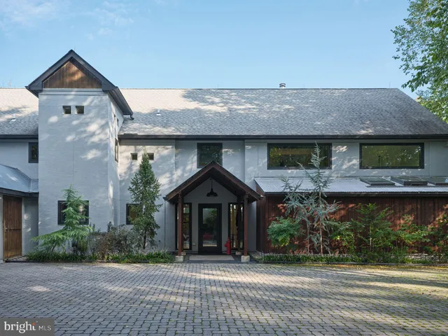 a view of a house with garden and a tree