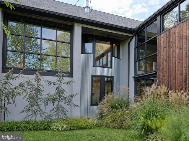 a bathroom with a granite countertop sink a mirror and shower