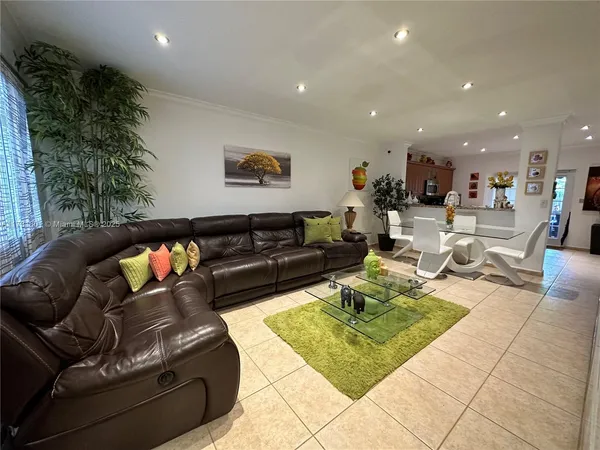 a living room with furniture and a potted plant