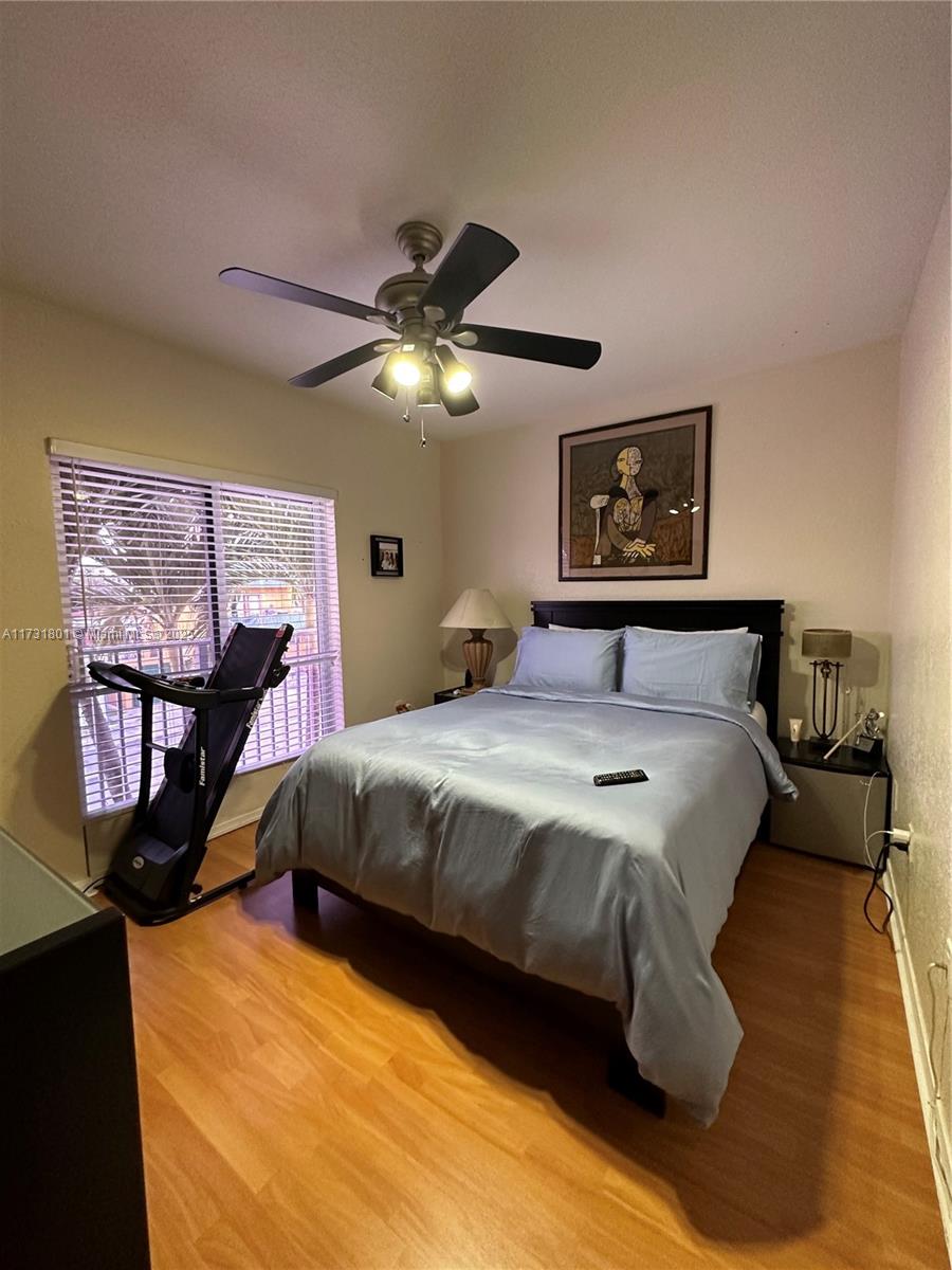 425 East 3rd Avenue, Unit 6 Hialeah, FL 33010 - Photo 15 of 24 a bedroom with a bed and wooden floor