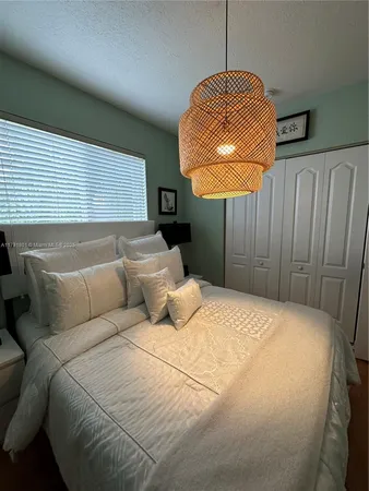 a bed room with a bed mirror and a window