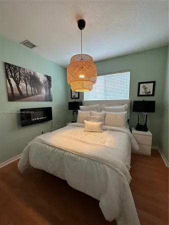 a bedroom with bed and window