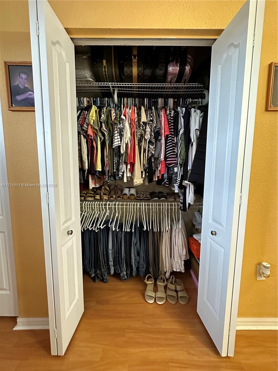 425 East 3rd Avenue, Unit 6 Hialeah, FL 33010 - Photo 21 of 24 a view of walk in closet with clothes and shoes