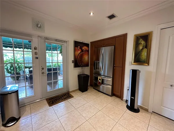 a kitchen with stainless steel appliances granite countertop a refrigerator and a sink