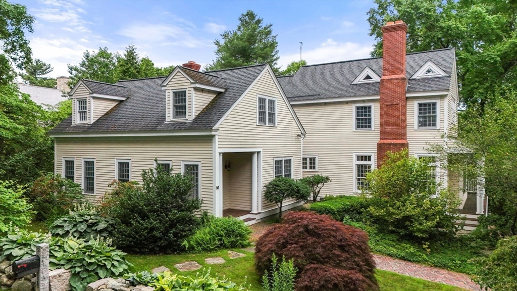 a aerial view of a house with a yard and potted plants