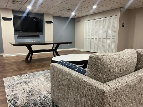 a living room with furniture and a wooden floor