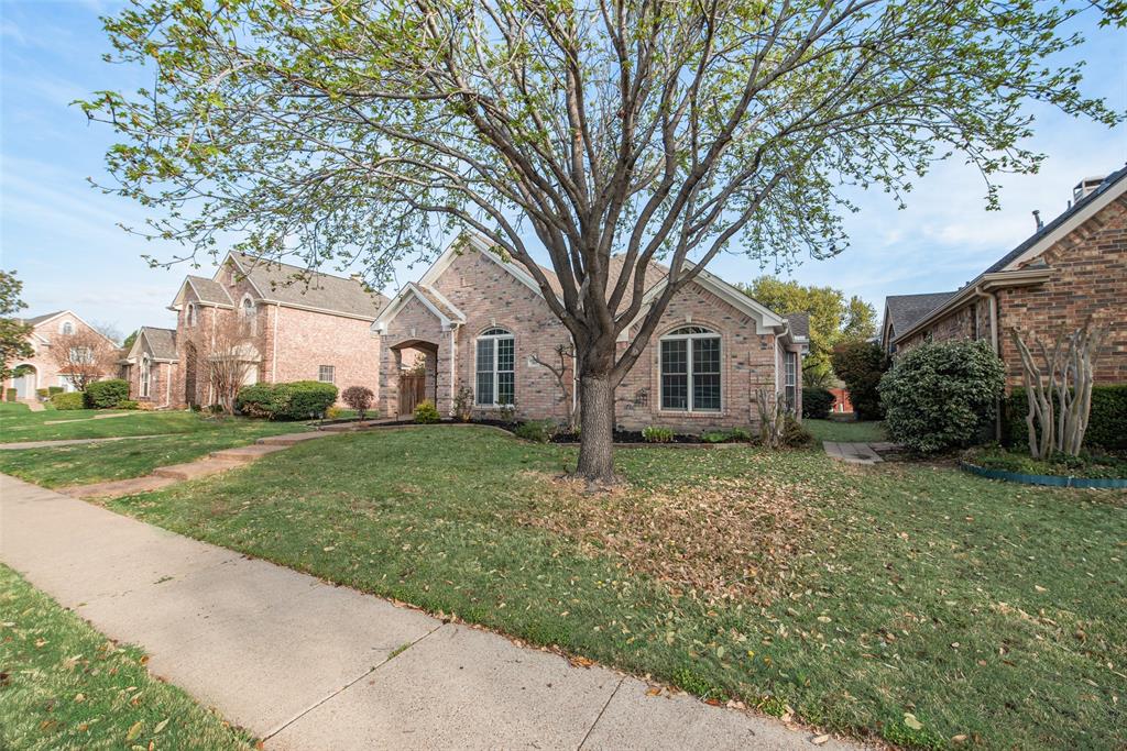 View of front facade featuring brick siding and a front lawn