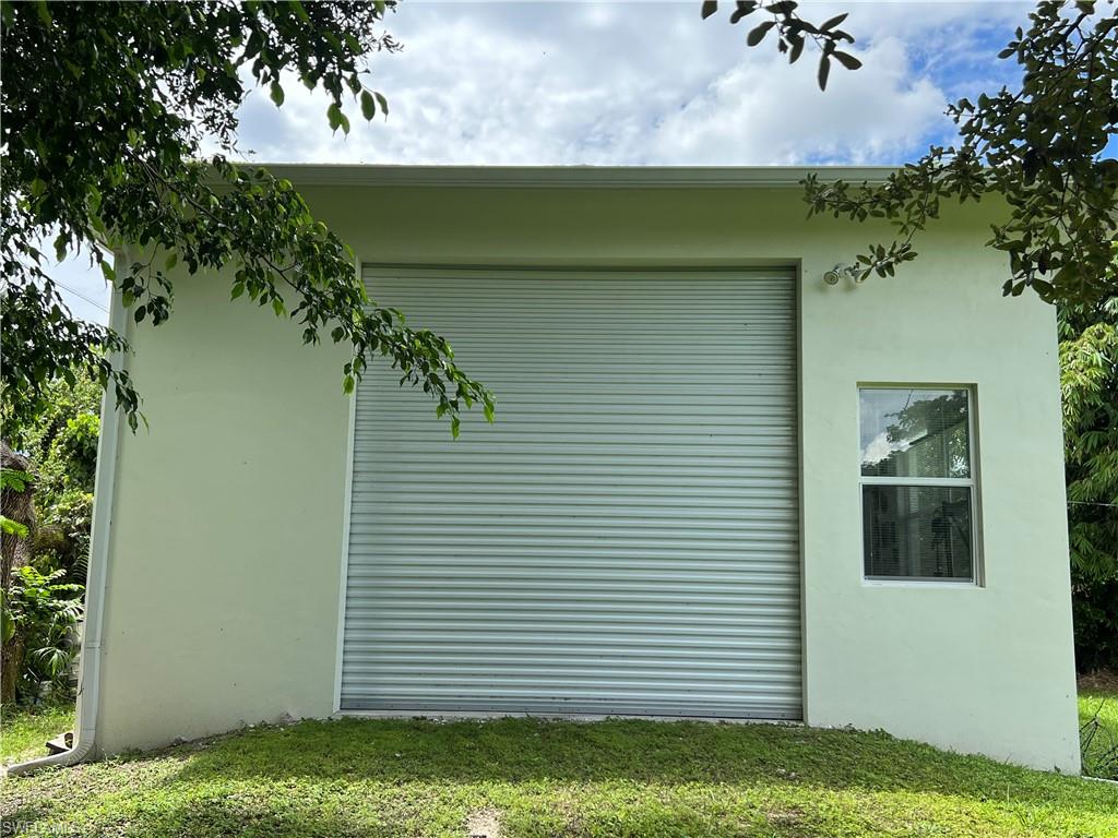 2670 Storter Avenue Naples, FL 34112 - Photo 7 of 11 a view of a backyard with plants and a bench