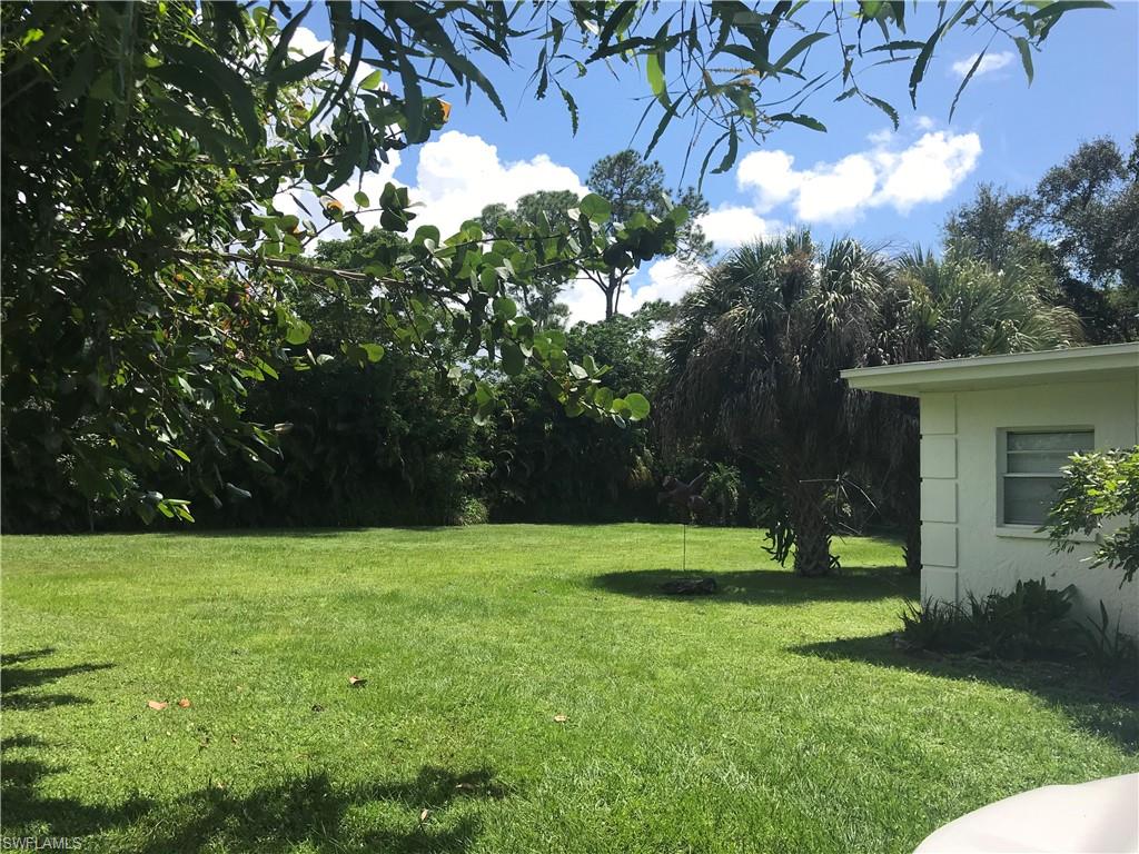 2670 Storter Avenue Naples, FL 34112 - Photo 9 of 11 a view of green field with trees in the background