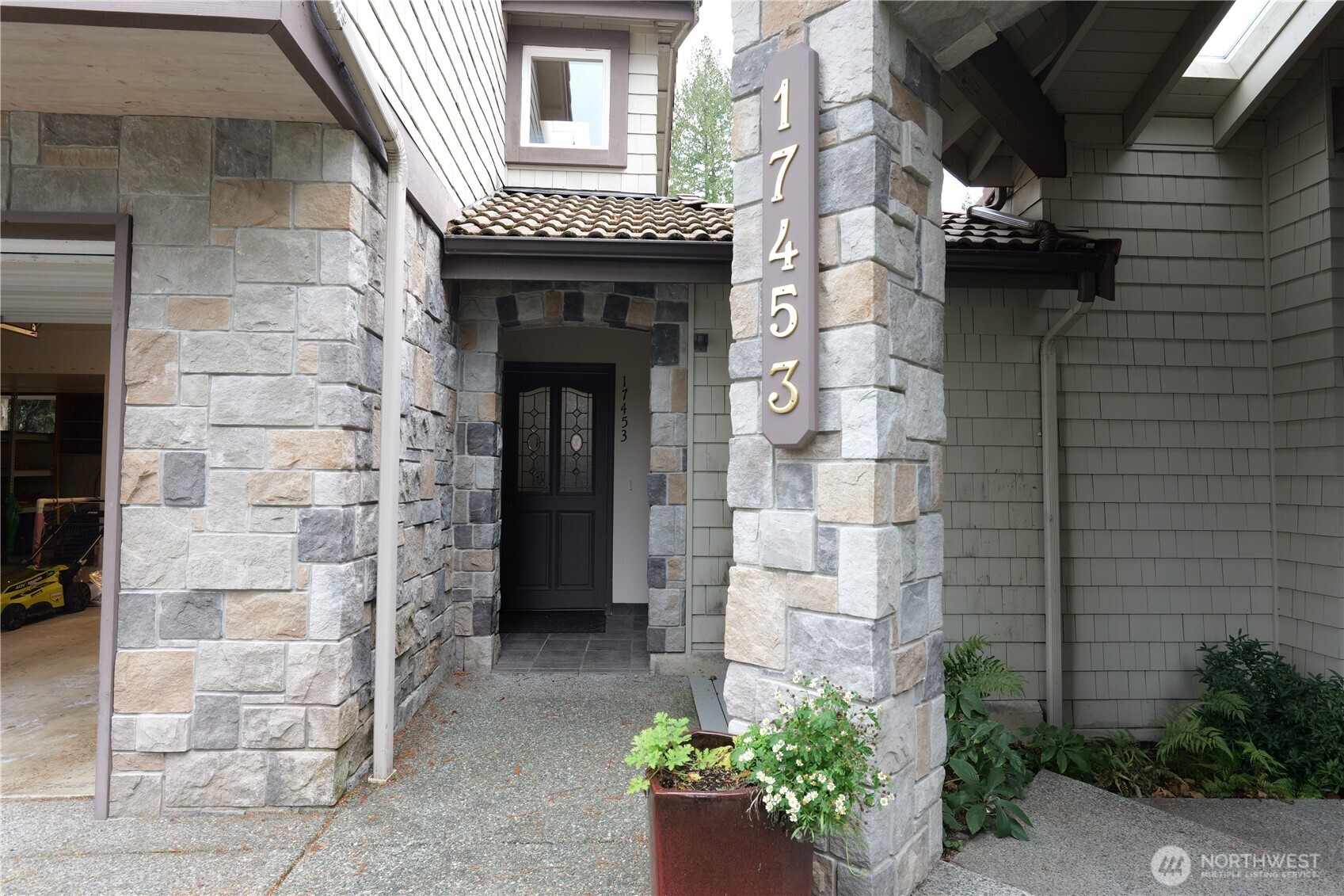 a front view of a house with potted plants