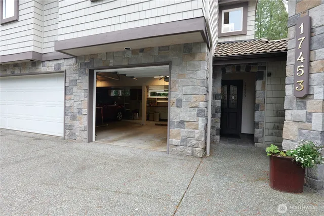 a view of a brick house with potted plants