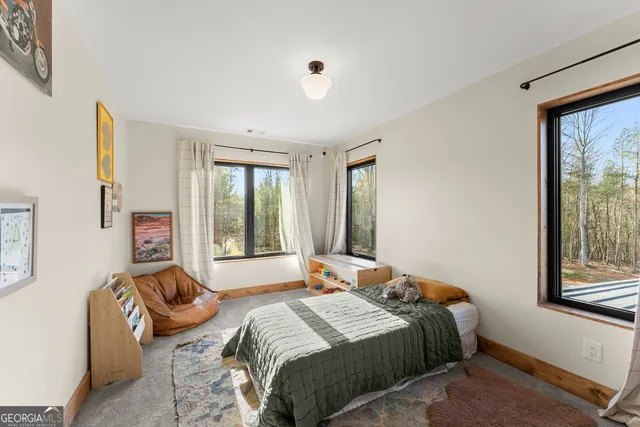 a view of a room that has a bed and a chair in it