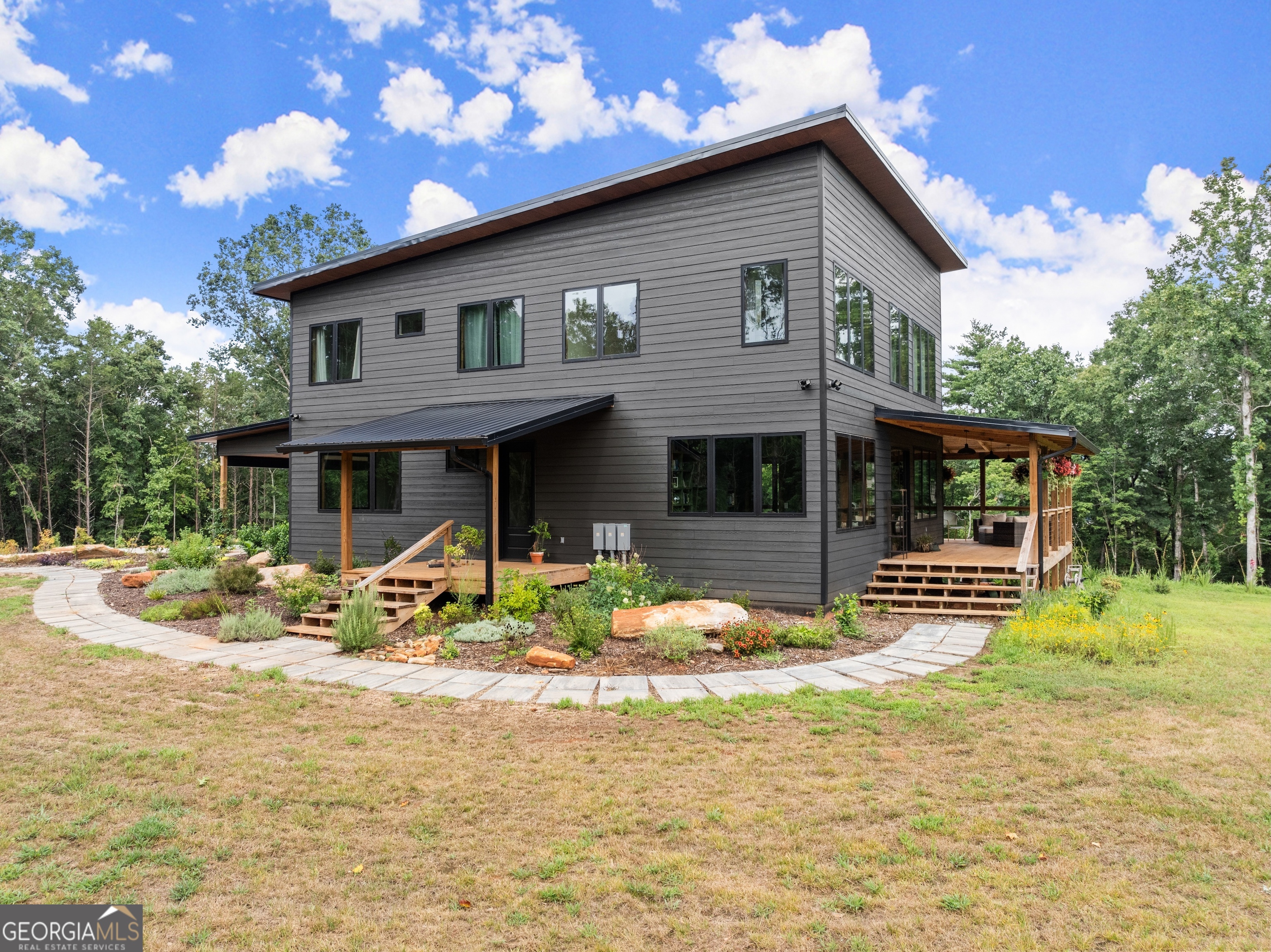 147 Jess Hunt W 60 Acres Road Cleveland, GA 30528 - Photo 5 of 69 a front view of a house with garden and porch