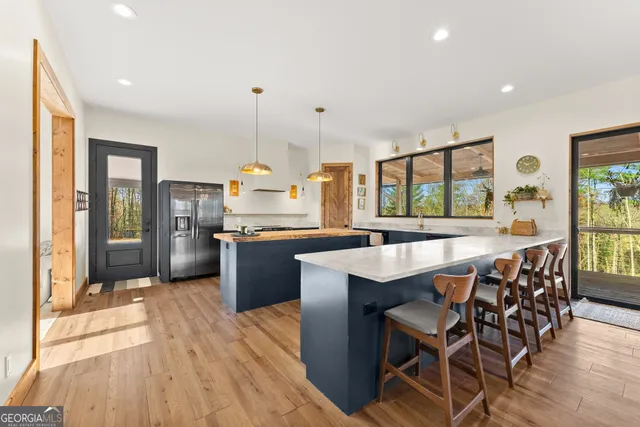 a kitchen with a stove and a wooden floor