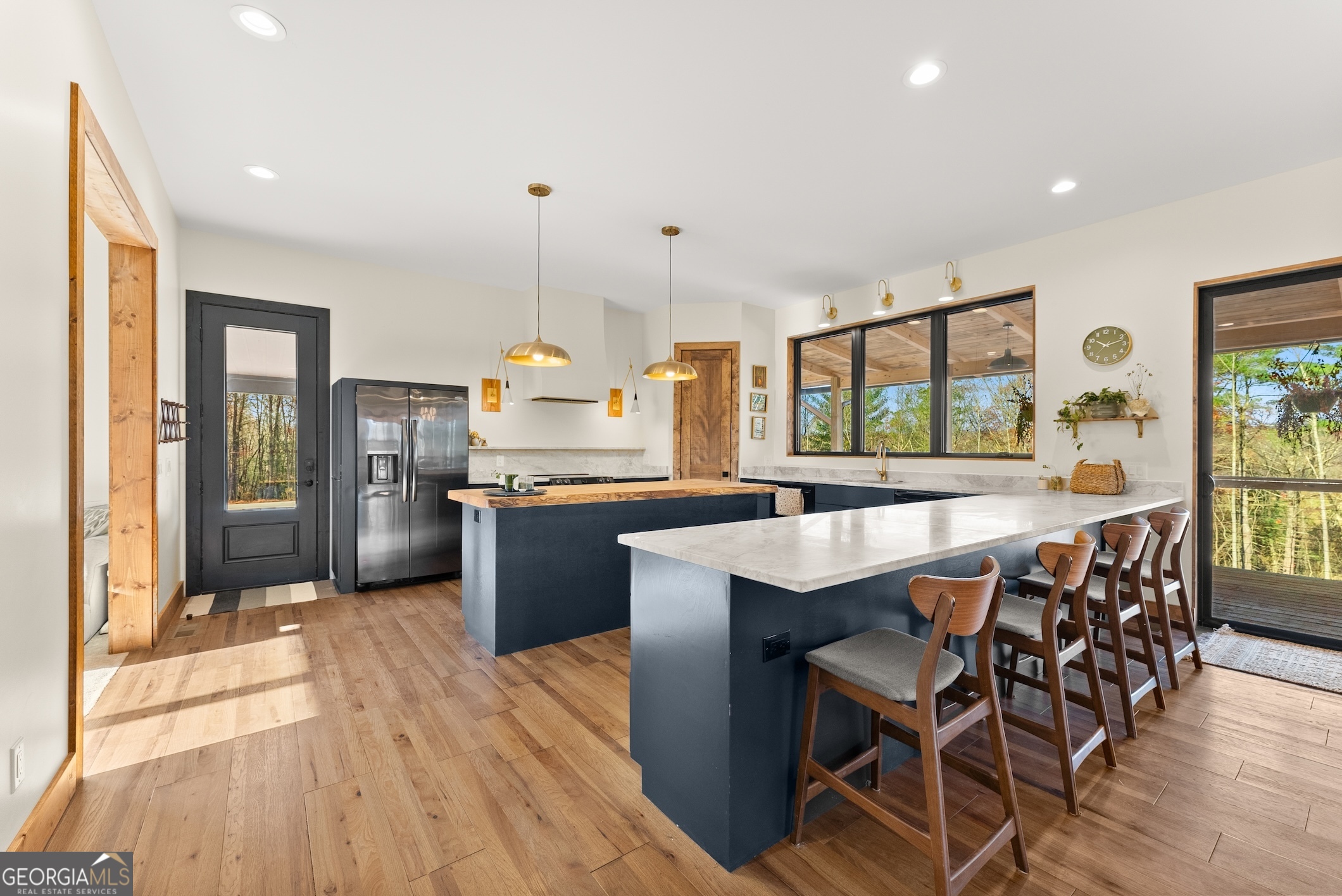 147 Jess Hunt W 60 Acres Road Cleveland, GA 30528 - Photo 9 of 69 a kitchen with stainless steel appliances kitchen island granite countertop a table chairs sink and cabinets