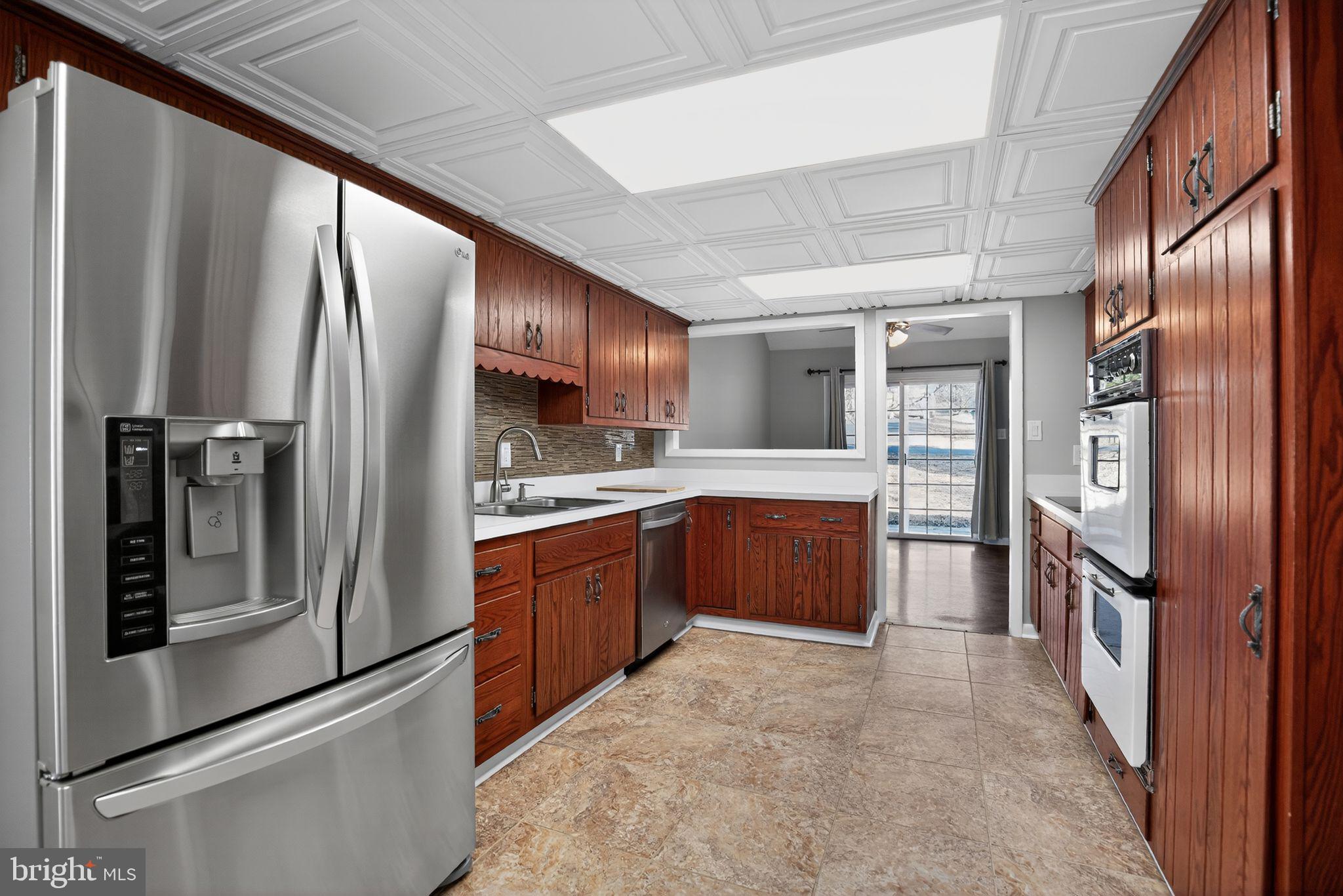40855 Spring House Lane Leonardtown, MD 20650 - Photo 16 of 68 a large kitchen with stainless steel appliances and large refrigerator