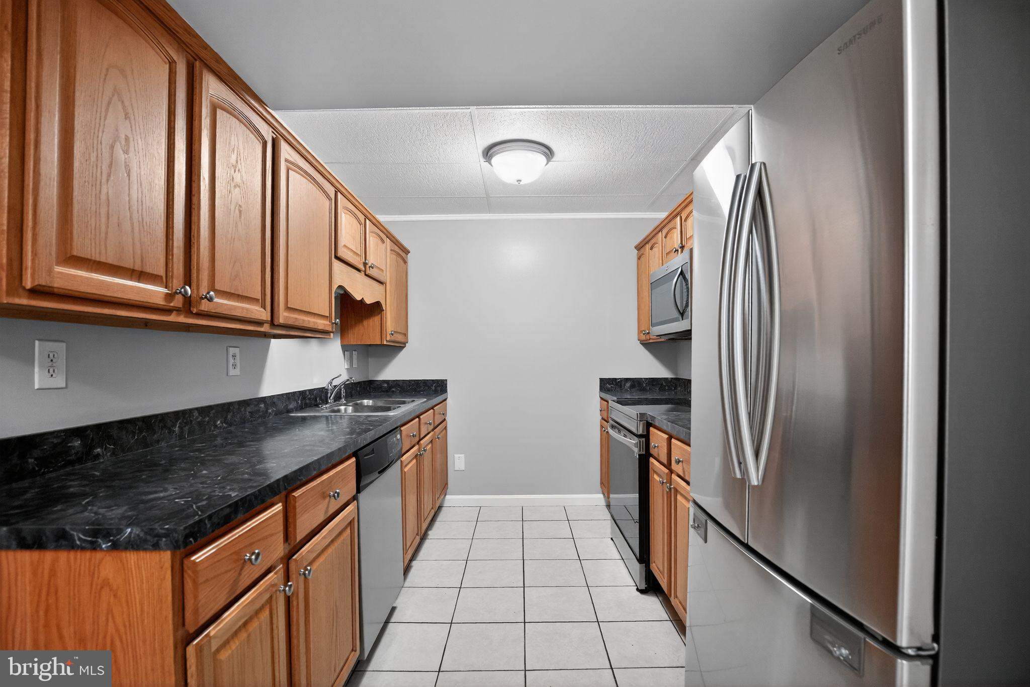 40855 Spring House Lane Leonardtown, MD 20650 - Photo 35 of 68 a kitchen with stainless steel appliances granite countertop a refrigerator and a stove
