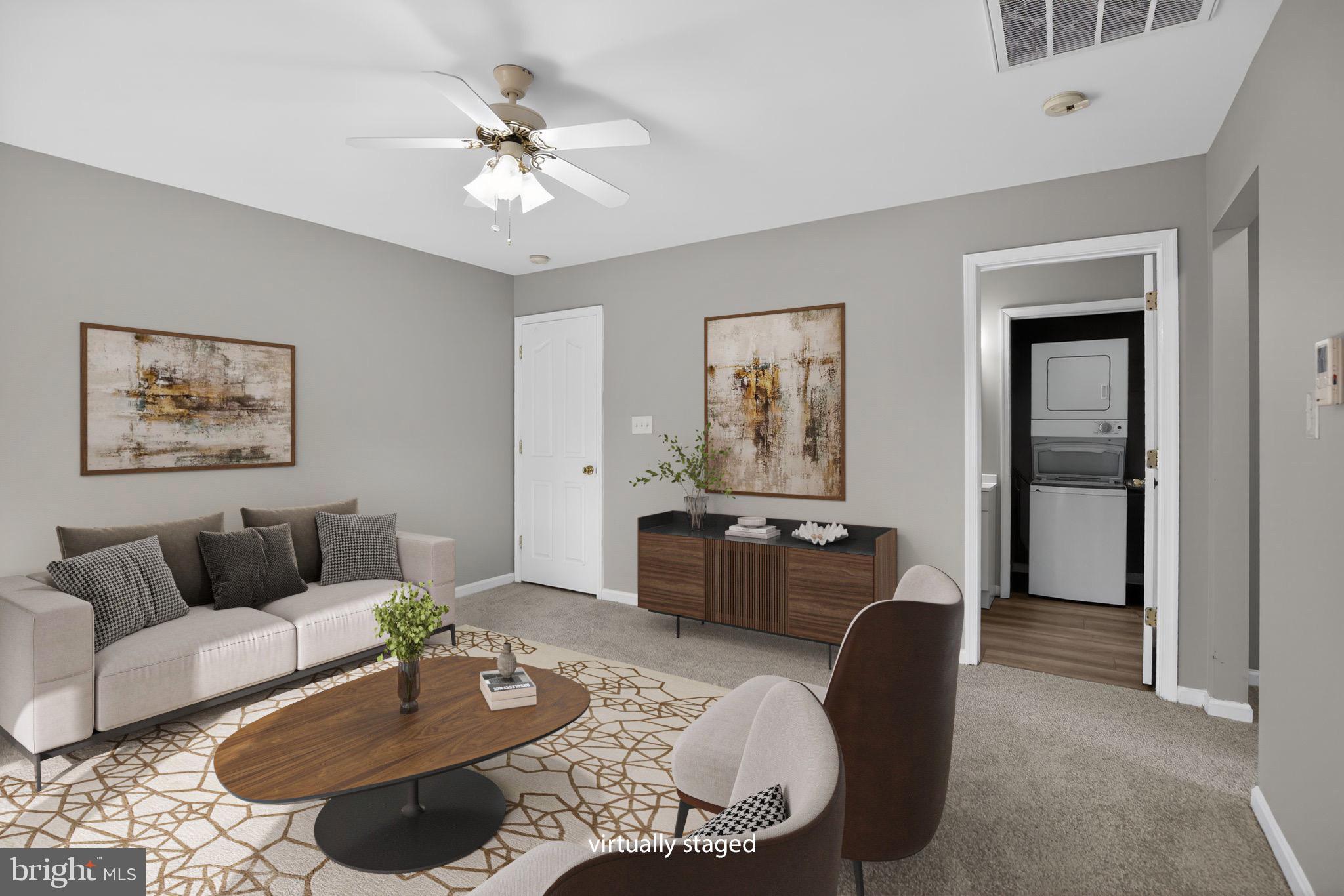 40855 Spring House Lane Leonardtown, MD 20650 - Photo 42 of 68 a living room with furniture and a chandelier