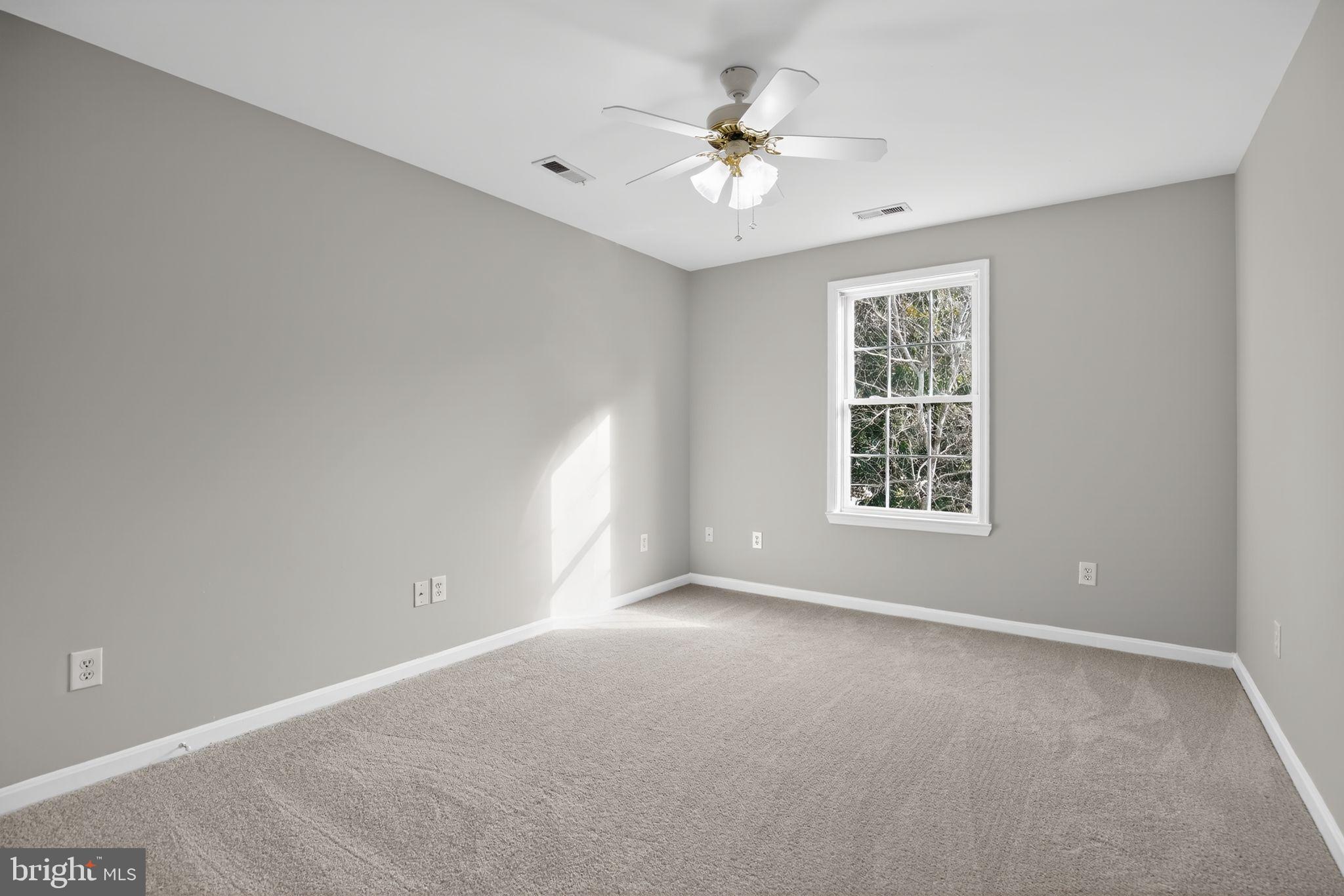 40855 Spring House Lane Leonardtown, MD 20650 - Photo 46 of 68 an empty room with windows and chandelier fan
