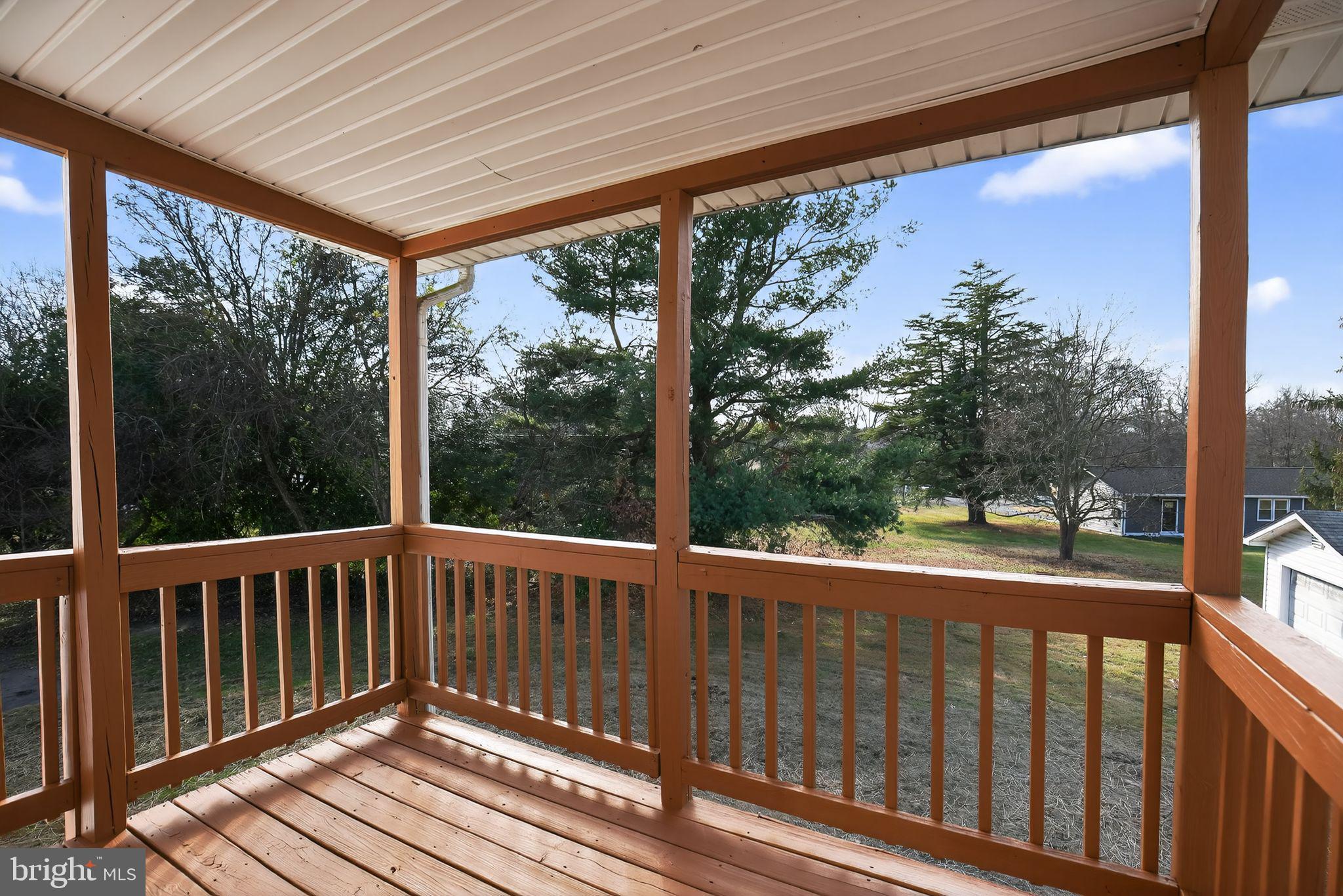 40855 Spring House Lane Leonardtown, MD 20650 - Photo 50 of 68 a view of a porch with wooden floor in front of a house