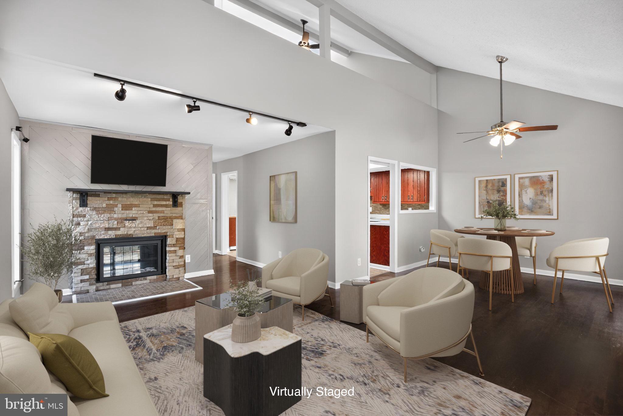 40855 Spring House Lane Leonardtown, MD 20650 - Photo 8 of 68 a living room with furniture a fireplace and a flat screen tv