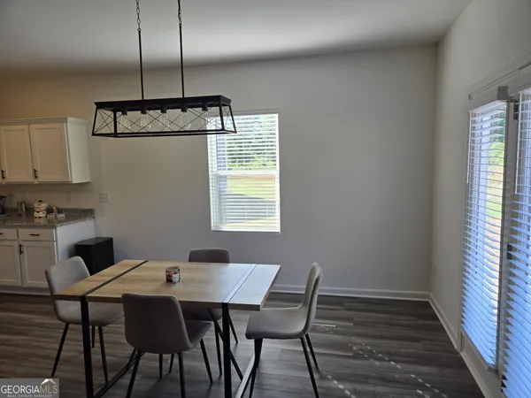a kitchen with a table and chairs in it