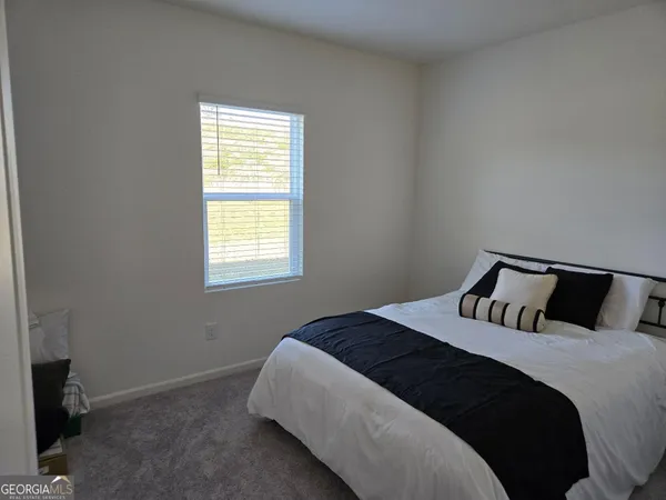 a bedroom with a bed and window