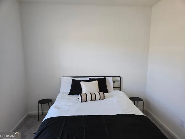 a bedroom with a bed and a chair