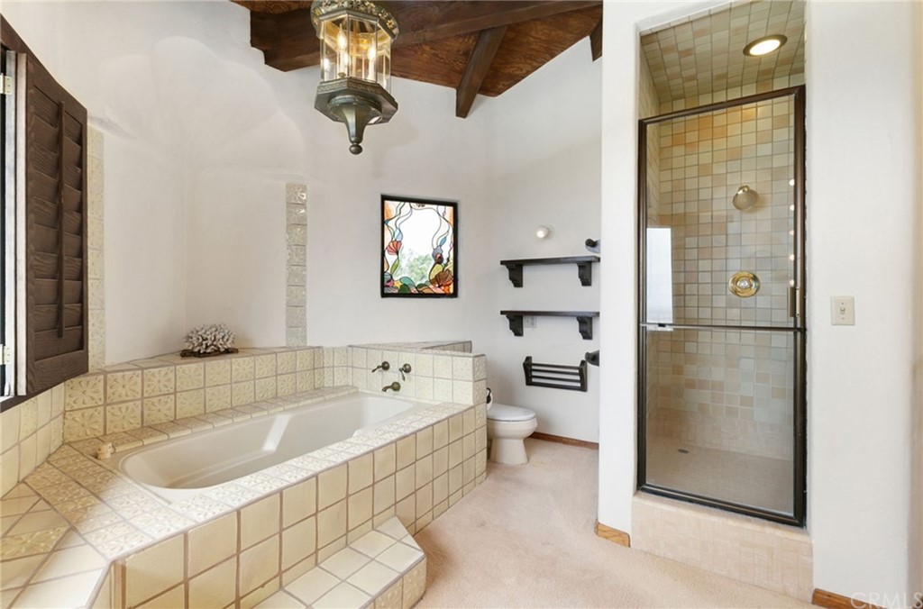 14081 Summit Drive Whittier, CA 90602 - Photo 23 of 61 a bathroom with a tub sink toilet and window