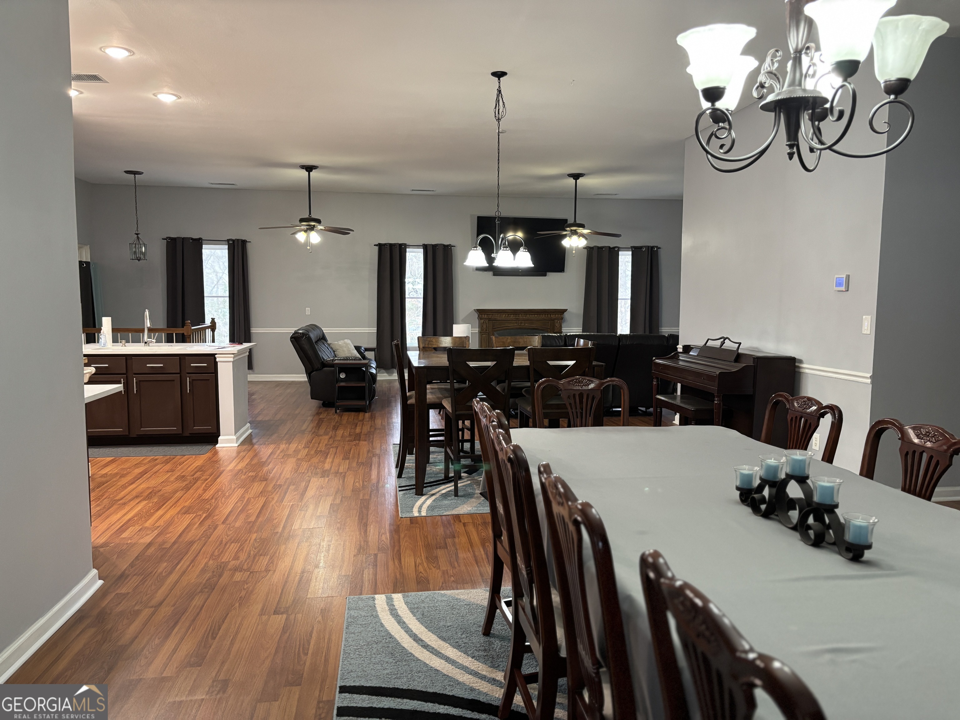 817 Brookside Drive Winder, GA 30680 - Photo 11 of 73 a view of a dining room and livingroom with furniture wooden floor a chandelier