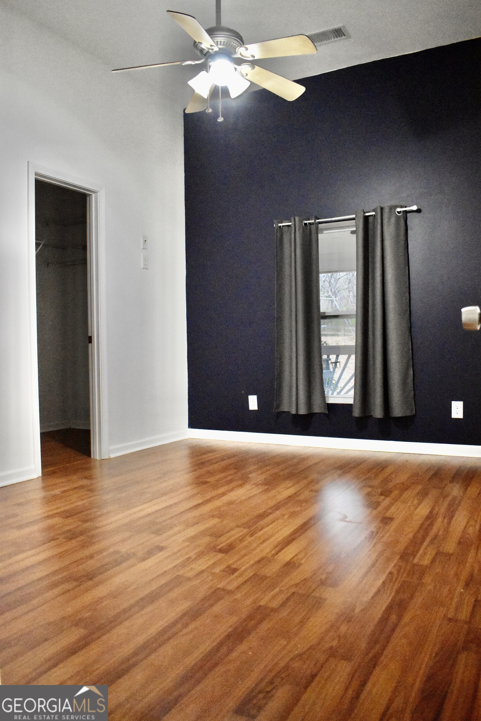 817 Brookside Drive Winder, GA 30680 - Photo 27 of 73 a view of an empty room with wooden floor and a window