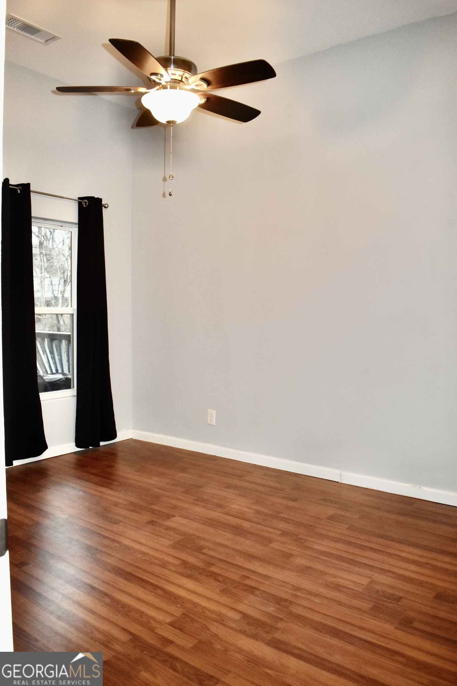 817 Brookside Drive Winder, GA 30680 - Photo 31 of 73 a view of an empty room with window and wooden floor