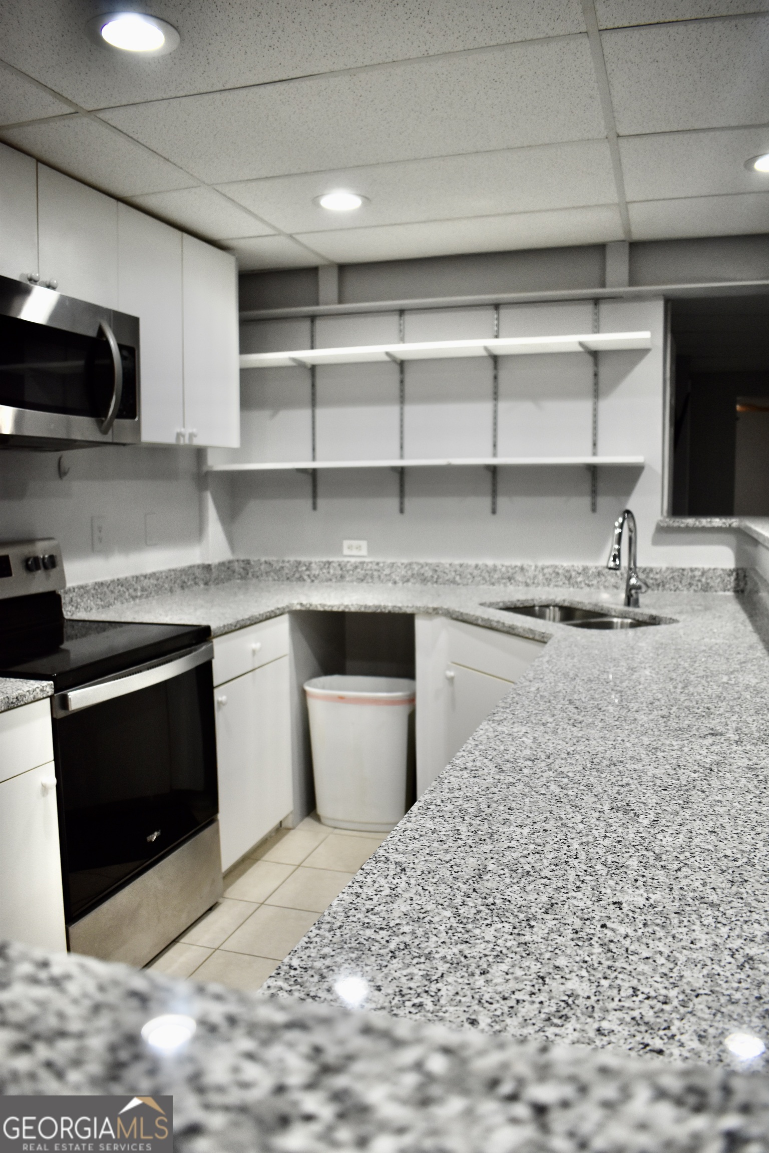 817 Brookside Drive Winder, GA 30680 - Photo 50 of 73 a kitchen with stainless steel appliances granite countertop a stove a sink and a microwave