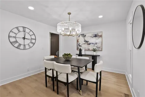 a view of a dining room with furniture and a chandelier