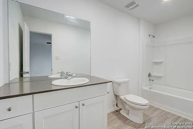 10707 Margarita Loop Converse, TX 78109 - Photo 28 of 32 Bathroom with vanity, tub / shower combination, and light wood-style floors