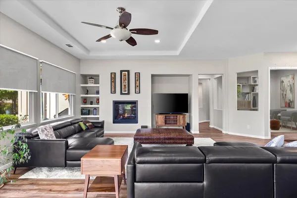 a kitchen with stainless steel appliances granite countertop a stove top oven a sink and a dining table with granite countertops