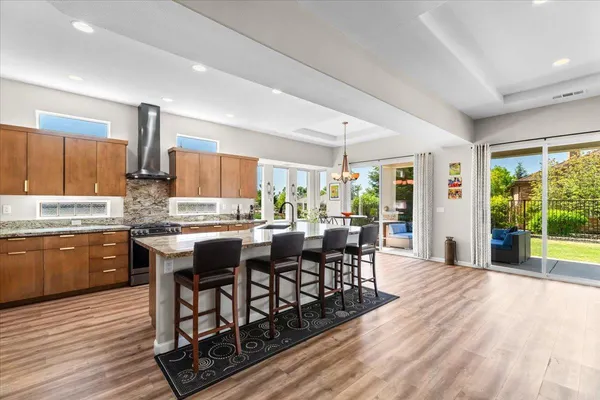 a kitchen with stainless steel appliances granite countertop a refrigerator stove microwave and sink