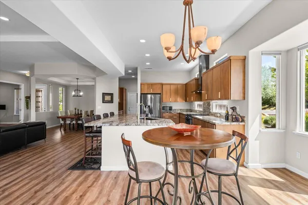 a kitchen with stainless steel appliances a refrigerator and a refrigerator