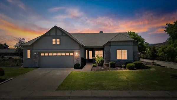 an aerial view of a city with lots of residential buildings and mountain view in back