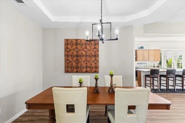 a view of a patio with couches potted plants and floor to ceiling window