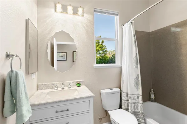a patio with table and chairs and potted plants